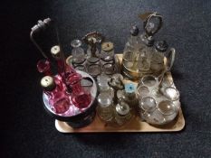 A tray of five antique plated cruet stands and assorted cruet bottles