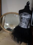 A mannequin torso together with an early twentieth century oval gilt framed mirror