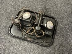 Two black Bakelite telephones