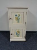 An antique painted pine double door cabinet