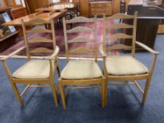 A set of six Ercol elm ladder backed dining chairs comprising of two carvers, four singles.