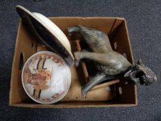 A nineteenth century blue and white meat plate, decorative tiger figure, wooden bottle rack,