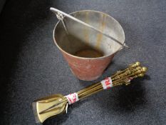 A set of antique brass fire irons together with a fire bucket