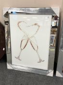 A mirrored framed picture of wine glasses