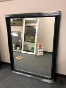 A black framed overmantel mirror