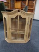 A stripped pine wall cabinet