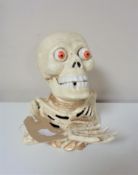 A cast iron skeleton money box