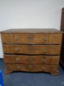 A nineteenth century oak serpentine fronted chest on bracket feet