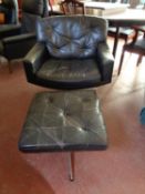 A mid century Danish black buttoned leather armchair with similar stool