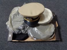 A box of seven assorted military caps