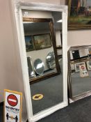 A white framed mirror 5' by 2'