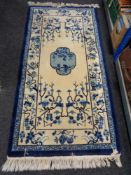A blue fringed Chinese rug,