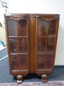 A 1930's oak double door display cabinet