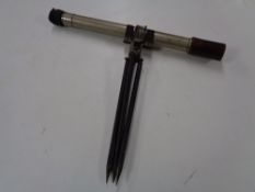 A military telescope on tripod together with a periscope viewer