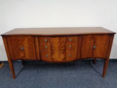An inlaid mahogany Regency style serpentine fronted sideboard