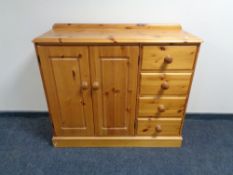 A pine double door sideboard fitted with four drawers