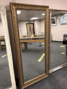 A gold ornate framed mirror