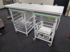 Two medical trolleys fitted with trays and baskets