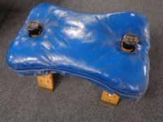 A camel stool with leather saddle