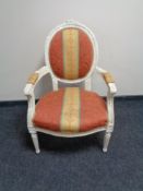 A white salon armchair in striped fabric