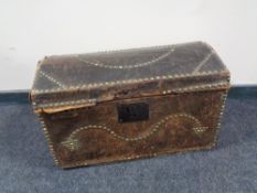 A Georgian pine domed topped trunk in brass studded leather bearing initials J J