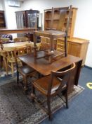 A 1930's oak drop leaf table and three chairs