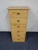 A pine effect six drawer chest