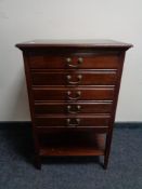 An Edwardian mahogany five drawer music cabinet