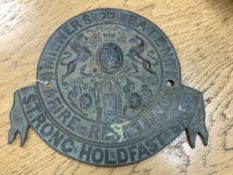 A cast metal circular safe-maker's plate : Milners' Patent, diameter 23 cm.