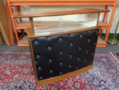 A mid 20th century teak black vinyl upholstered cocktail bar