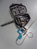 A cased performance petrol chain saw together with an Skacto electric chainsaw - no lead