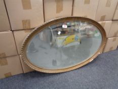 An early 20th century oval gilt framed bevelled edge mirror