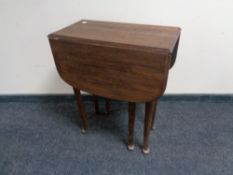 An oak gate leg table on club feet