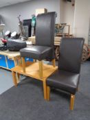 A beech coffee table together with a pair of leather chairs