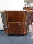 A 1930's side by side walnut bureau display cabinet