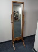An Edwardian oak cheval mirror
