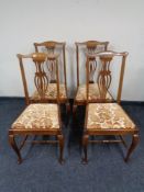 A set of four Edwardian oak dining chairs