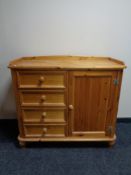 A pine single door sideboard fitted four drawers