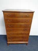 A mid century continental seven drawer chest