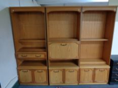 A multi section teak effect wall unit