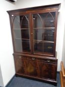 A mahogany double door bookcase fitted with three cupboards