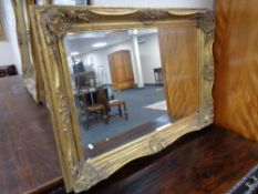 An ornate Victorian style gilt framed overmantel mirror 112 cm x 81 cm.