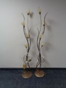 A pair of metal floor lamps