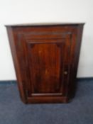 A George III oak hanging corner cabinet
