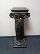 A plaster pedestal plant stand