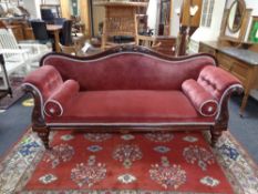 A Victorian mahogany scroll arm settee in pink dralon, width 215 cm, depth 70 cm.