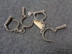 Two pairs of antique hand cuffs (one with key)