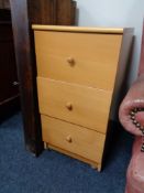 A pine effect three drawer chest