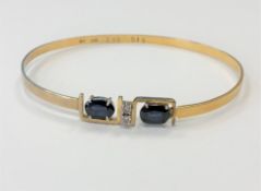 An 18ct gold sapphire and diamond bangle