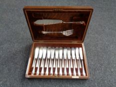 An Edwardian oak canteen containing desert cutlery